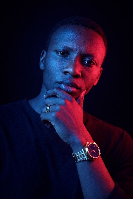 Portrait of Lenny Muriuki in neon blue and pink lighting